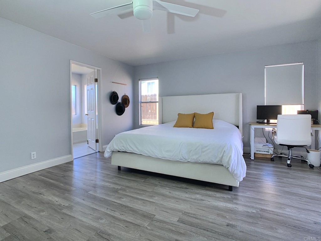 15935 Spring Oaks Road, Unit 63 El Cajon, CA 92021 - Photo 16 of 38 a bedroom with a bed and wooden floor