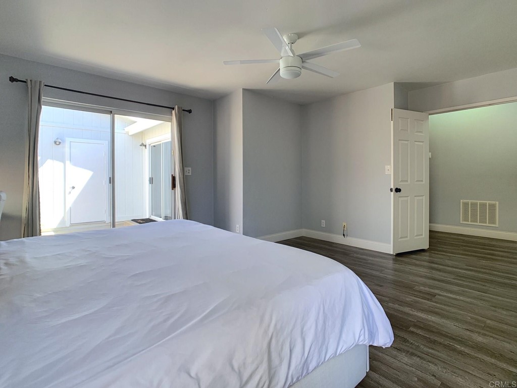 15935 Spring Oaks Road, Unit 63 El Cajon, CA 92021 - Photo 18 of 38 a bedroom with a bed and wooden floor