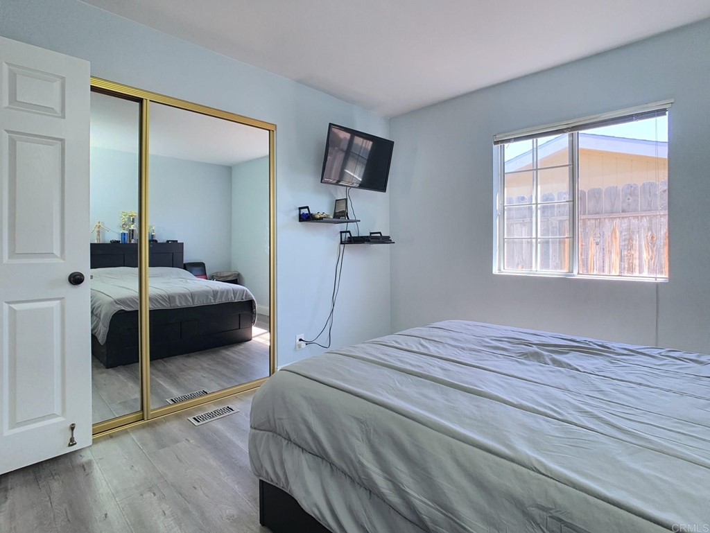 15935 Spring Oaks Road, Unit 63 El Cajon, CA 92021 - Photo 20 of 38 a bedroom with a bed and a large window