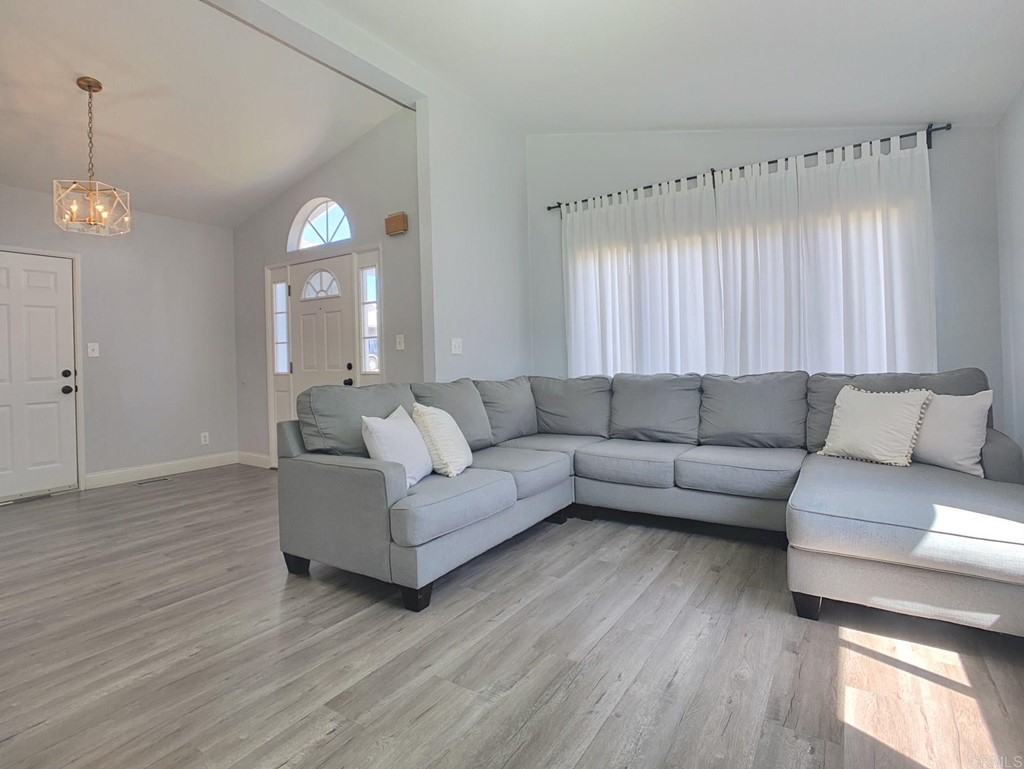 15935 Spring Oaks Road, Unit 63 El Cajon, CA 92021 - Photo 2 of 38 a living room with furniture and a chandelier