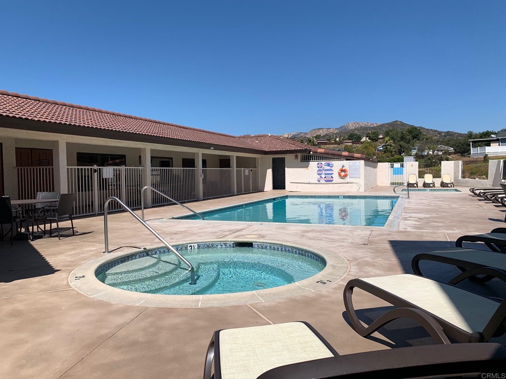 15935 Spring Oaks Road, Unit 63 El Cajon, CA 92021 - Photo 37 of 38 a view of a house with swimming pool and porch