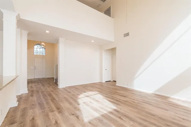 a view of an empty room and wooden floor