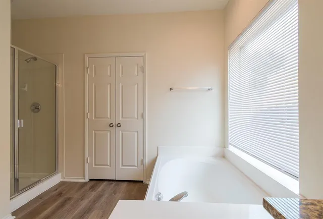 a bathroom with a bathtub and a window