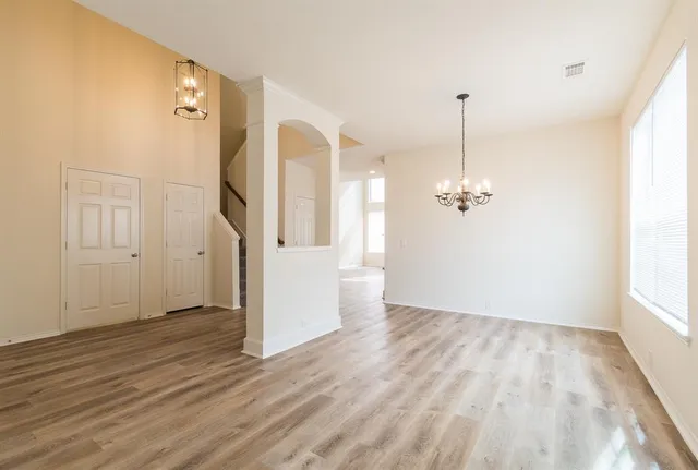 a view of a room with wooden floor and window