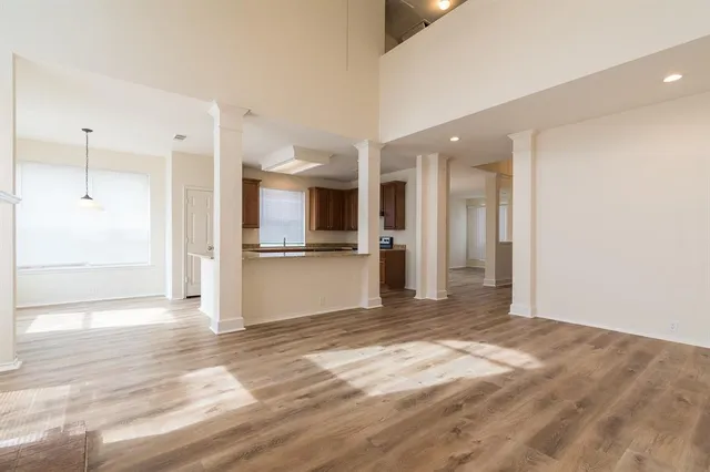 a view of a kitchen with wooden floor and a kitchen