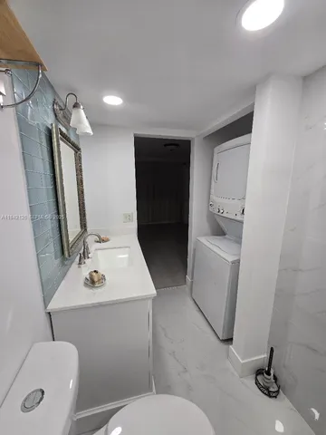 a bathroom with a sink toilet and mirror