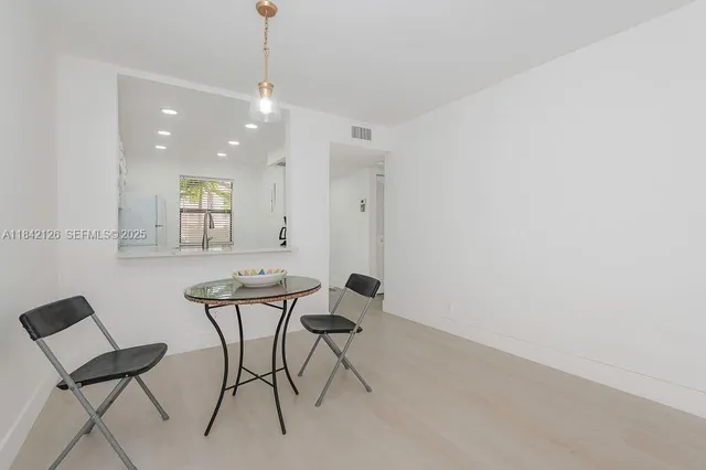 a view of a room with furniture and wooden floor