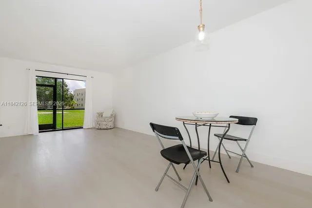 a view of a livingroom with furniture and swimming pool