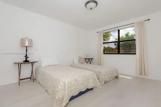 a bedroom with a bed and a night stand