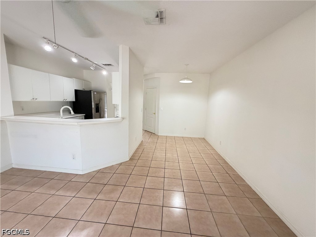 8541 Athena Court Lehigh Acres, FL 33971 - Photo 5 of 17 a view of a kitchen with a sink and a microwave