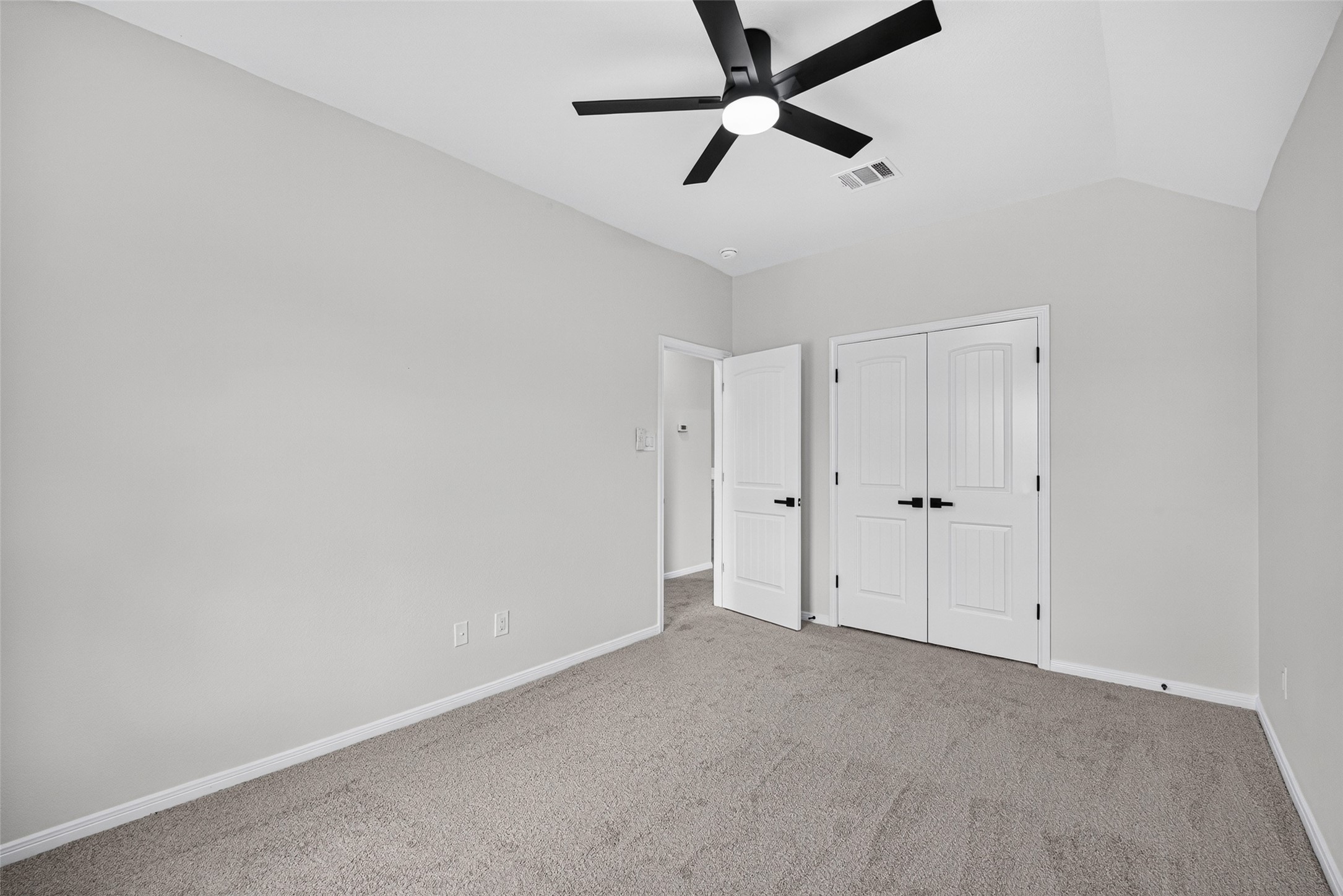 22623 Ebbets Field Drive Spring, TX 77389 - Photo 35 of 43 Relax into the expansive primary bedroom sanctuary where soft carpet underfoot and a sleek ceiling fan set a perfectly comfortable mood.