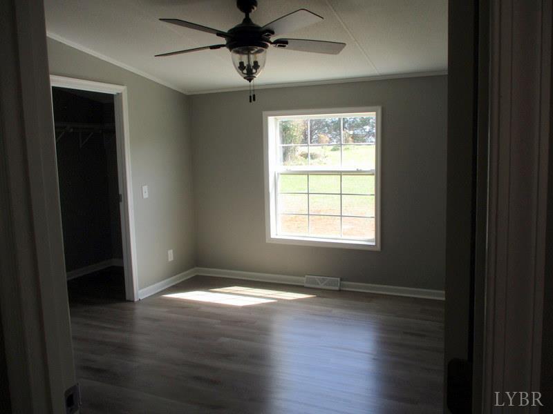 5629 Gladys Road Altavista, VA 24517 - Photo 12 of 29 a view of an empty room with wooden floor and a window