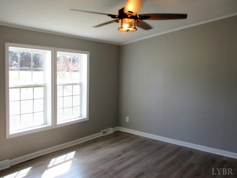 5629 Gladys Road Altavista, VA 24517 - Photo 20 of 29 an empty room with a window and wooden floor