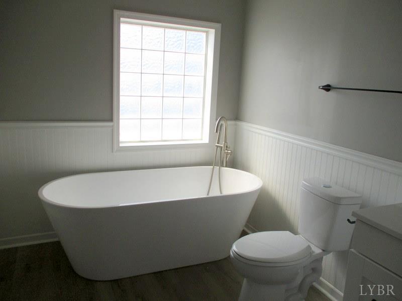 5629 Gladys Road Altavista, VA 24517 - Photo 25 of 29 a white bath tub sitting next to a toilet