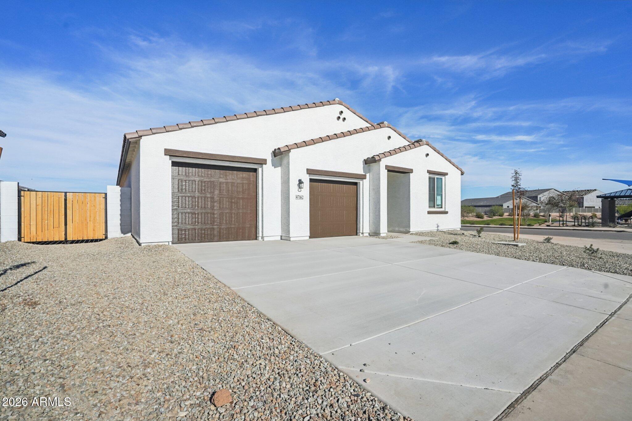 47162 West Cansados Road Maricopa, AZ 85139 - Photo 2 of 50 a view of a white house with a outdoor space