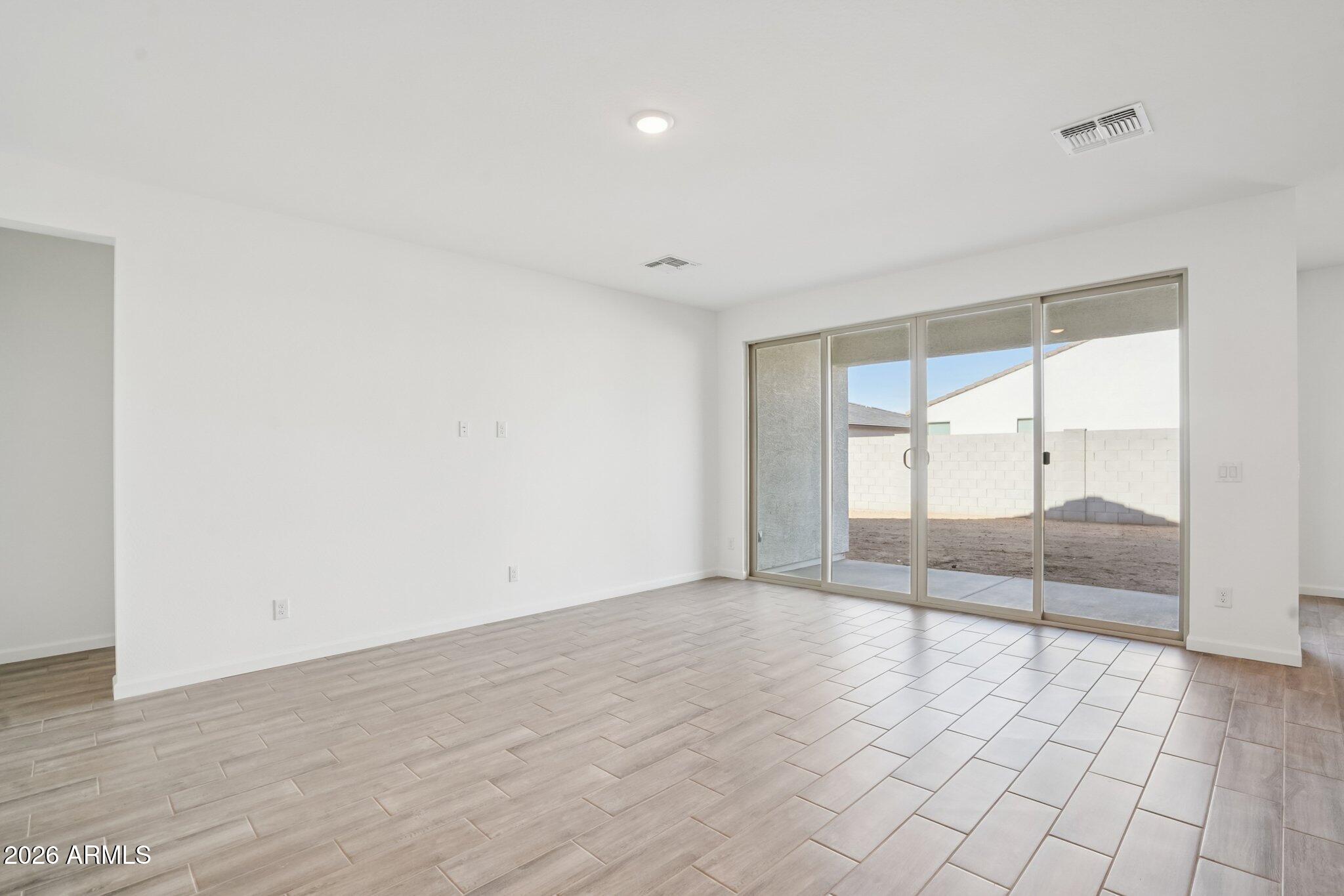 47162 West Cansados Road Maricopa, AZ 85139 - Photo 5 of 50 wooden floor in an empty room with a window