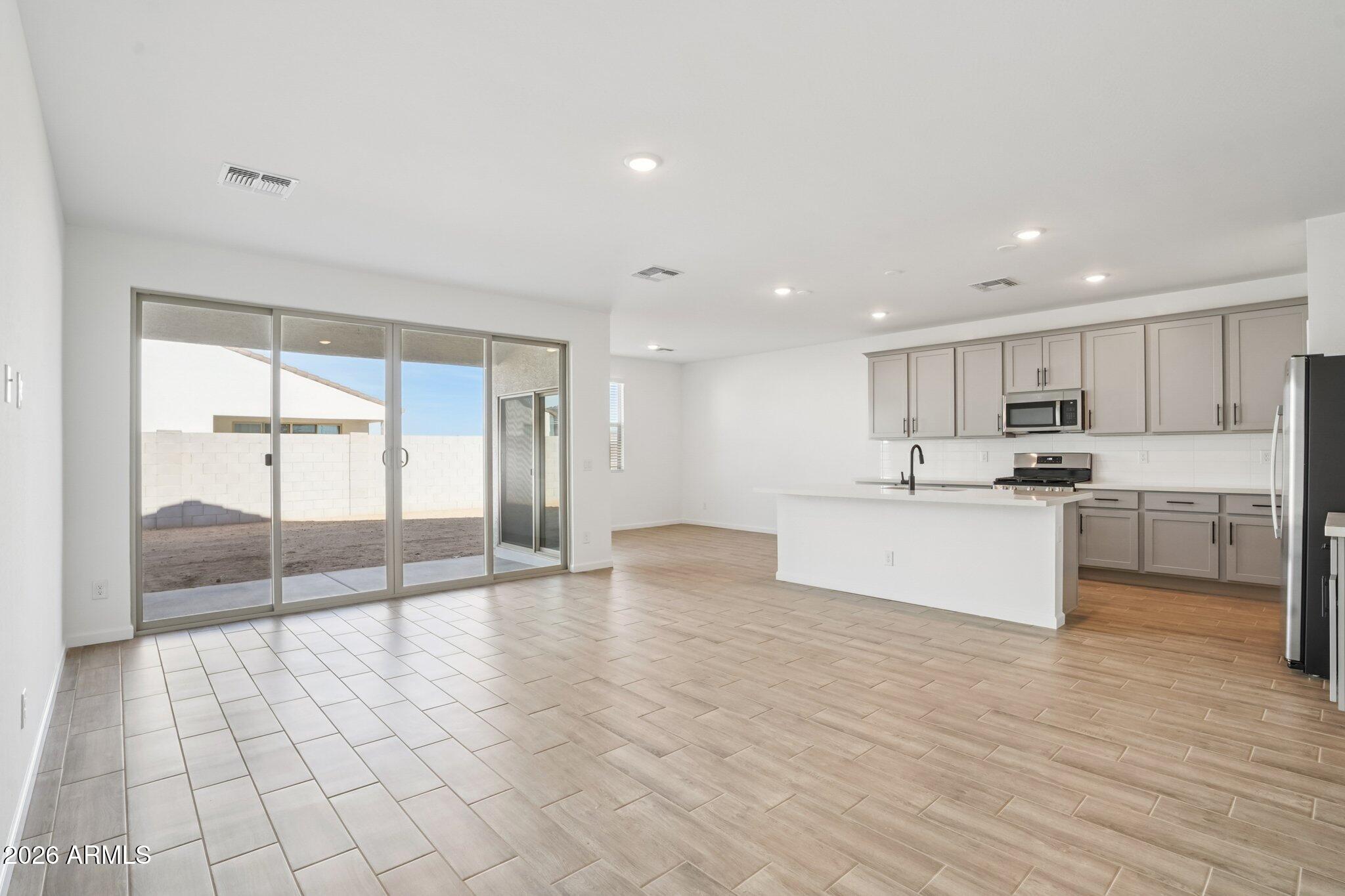 47162 West Cansados Road Maricopa, AZ 85139 - Photo 6 of 50 a large kitchen with cabinets and a wooden floor