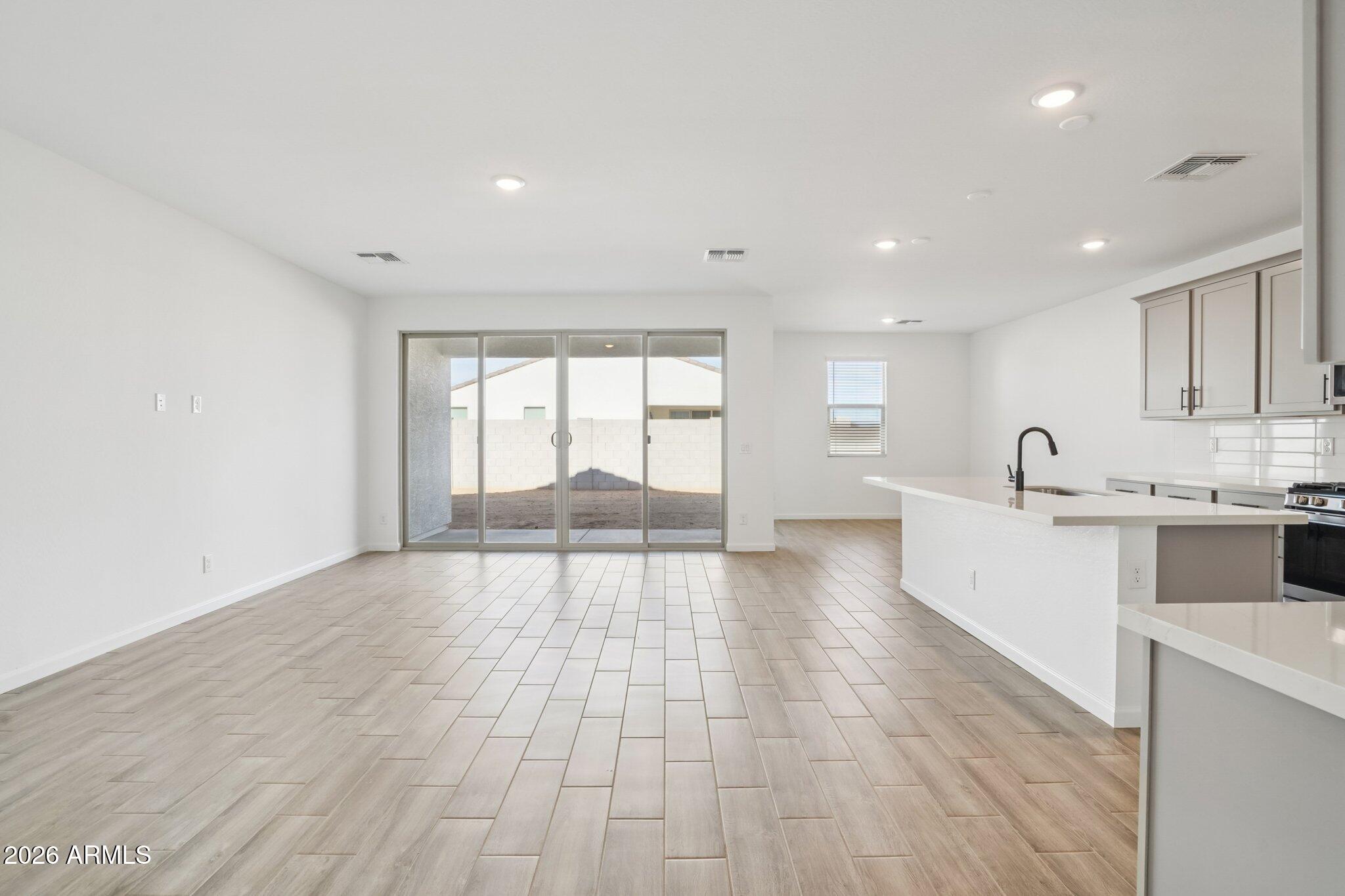 47162 West Cansados Road Maricopa, AZ 85139 - Photo 8 of 50 a big room with wooden floor and windows