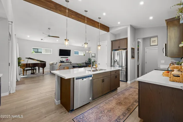 a kitchen with stainless steel appliances kitchen island granite countertop a stove and a sink