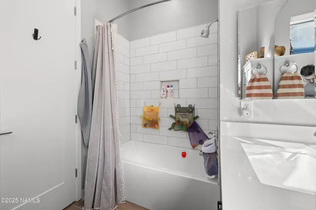 a bathroom with a tub and a shower