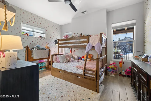 a bedroom with furniture and a baby crib