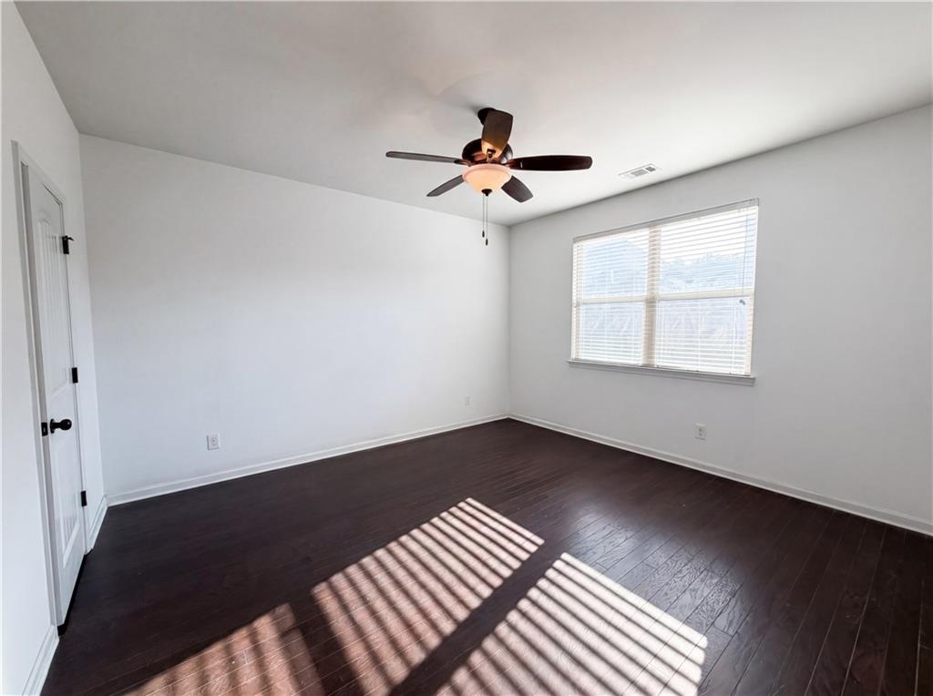 307 Valley View Trail Dallas, GA 30132 - Photo 20 of 41 an empty room with wooden floor ceiling fan and windows