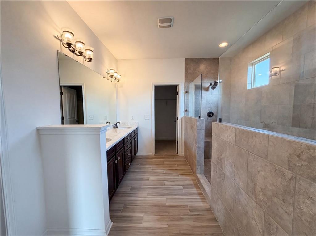 307 Valley View Trail Dallas, GA 30132 - Photo 31 of 41 a spacious bathroom with a double vanity sink and a mirror