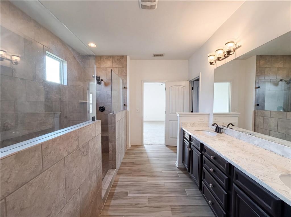 307 Valley View Trail Dallas, GA 30132 - Photo 34 of 41 a spacious bathroom with a granite countertop sink a toilet a mirror and shower