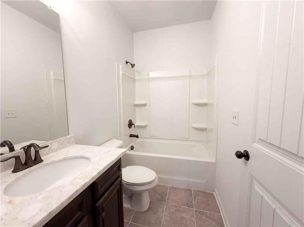 307 Valley View Trail Dallas, GA 30132 - Photo 38 of 41 a bathroom with a granite countertop sink toilet and shower