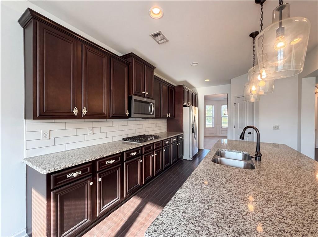 307 Valley View Trail Dallas, GA 30132 - Photo 10 of 41 a kitchen with stainless steel appliances granite countertop a sink stove and cabinets