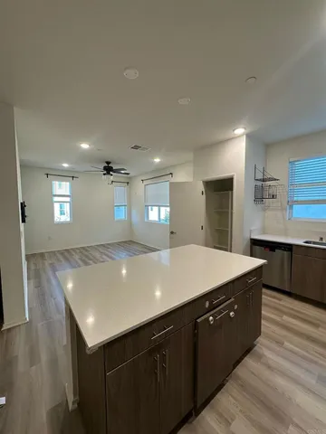 a view of a livingroom with a ceiling fan and window