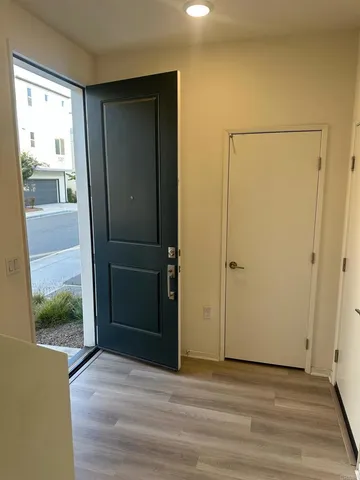 an empty room with wooden floor and a window