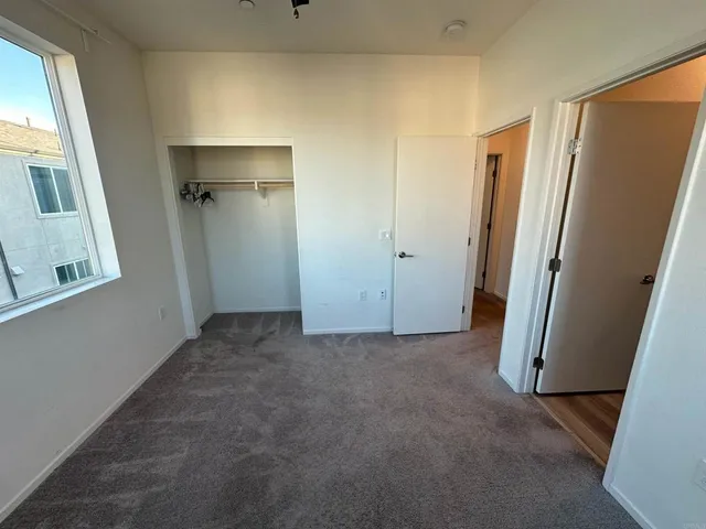 a view of a livingroom with wooden floor and a staircase