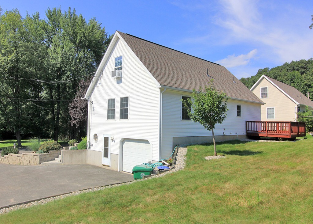 15 Cross Street Chicopee, MA 01013 - Photo 3 of 15 a view of a house with a yard and garage