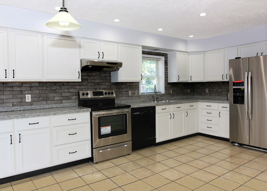 15 Cross Street Chicopee, MA 01013 - Photo 7 of 15 a kitchen with stainless steel appliances granite countertop a stove a sink and a refrigerator