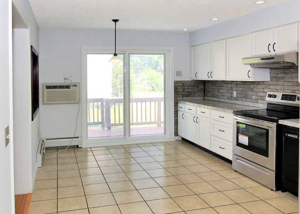 15 Cross Street Chicopee, MA 01013 - Photo 8 of 15 a kitchen with a stove a sink and a refrigerator