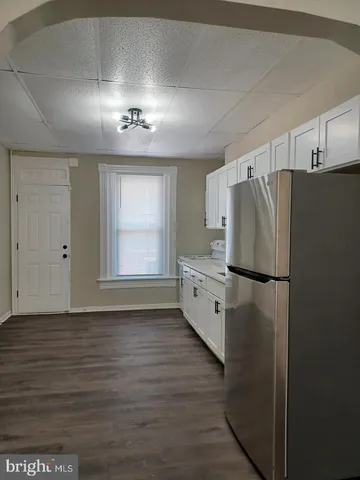 a kitchen with stainless steel appliances a refrigerator and a window