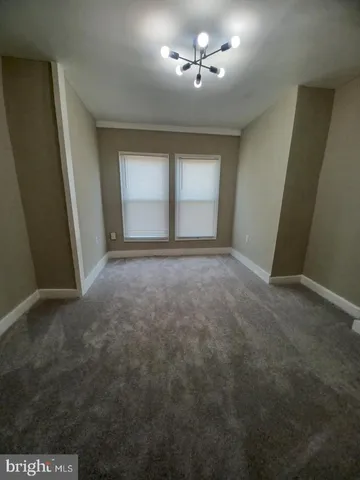 a view of room with a ceiling fan and window
