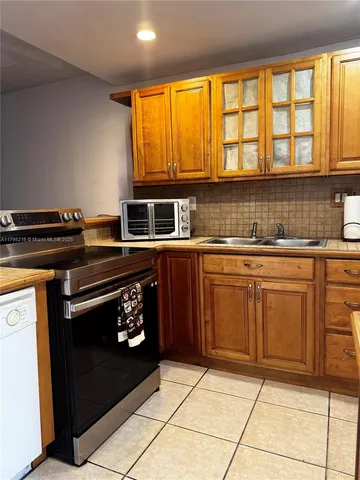 a kitchen with a stove a sink and a microwave