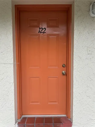 a bathroom with a glass door shower