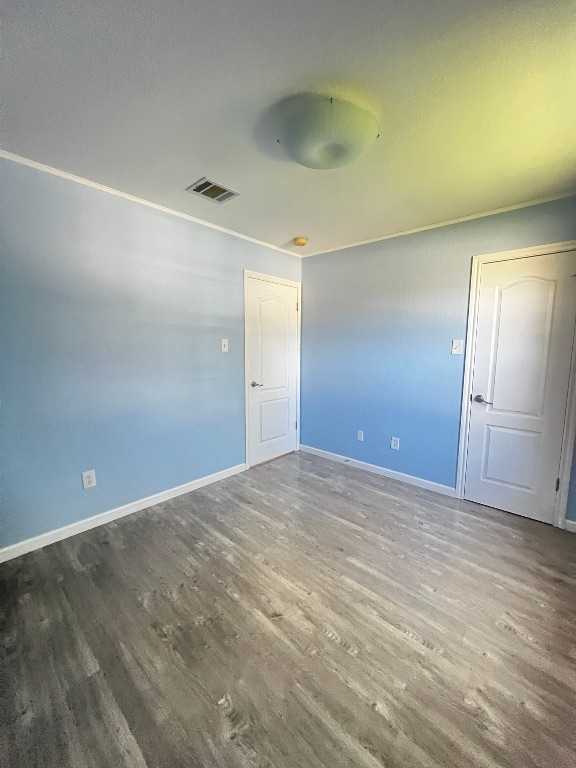 3503 Walleye Way Round Rock, TX 78665 - Photo 6 of 10 Empty room featuring wood finished floors and baseboards