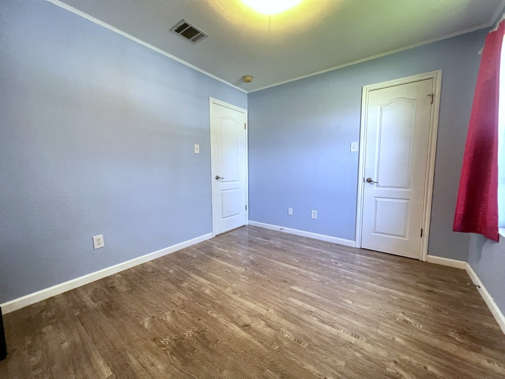 3503 Walleye Way Round Rock, TX 78665 - Photo 7 of 10 Spare room with wood finished floors and crown molding