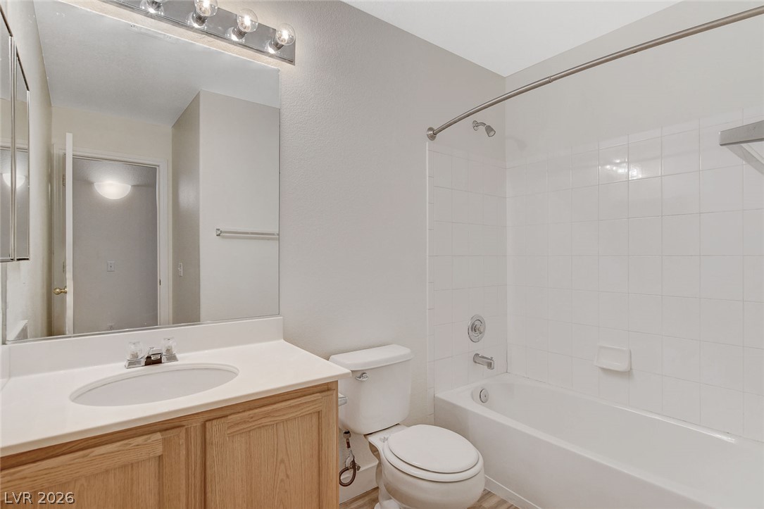 2052 Quarry Ridge Street, Unit 201 Las Vegas, NV 89117 - Photo 14 of 25 A well-appointed bathroom features a single vanity and a shower-tub combination with clean tile.