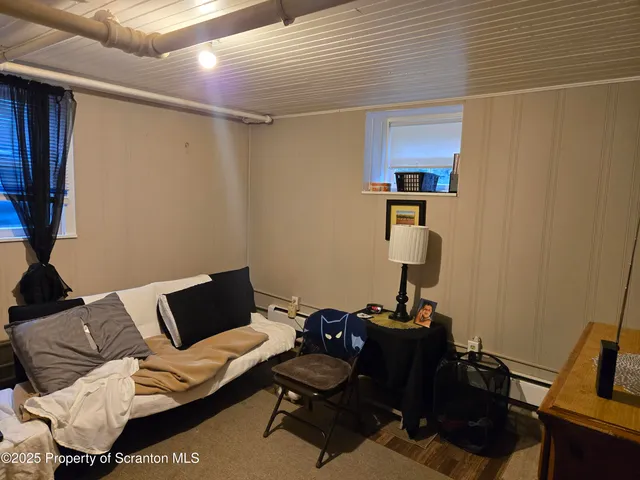a living room with furniture and a mirror