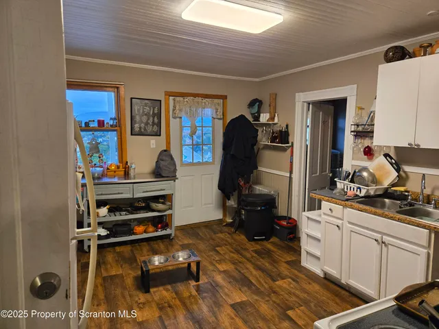 a room with furniture a flat screen tv and a window