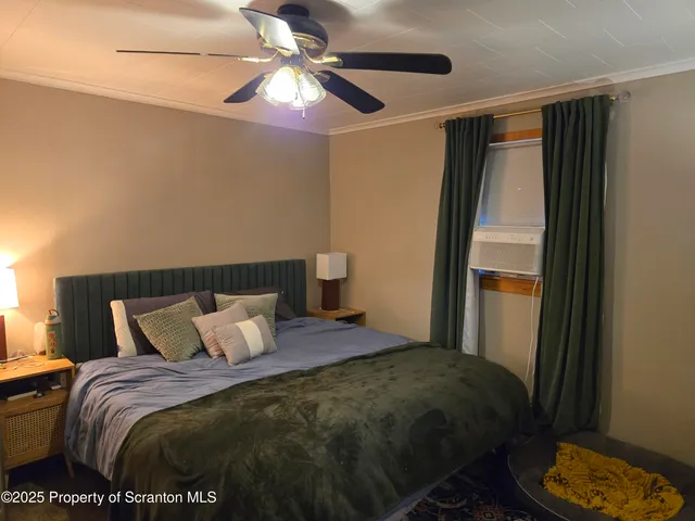 a bedroom with a bed and a window