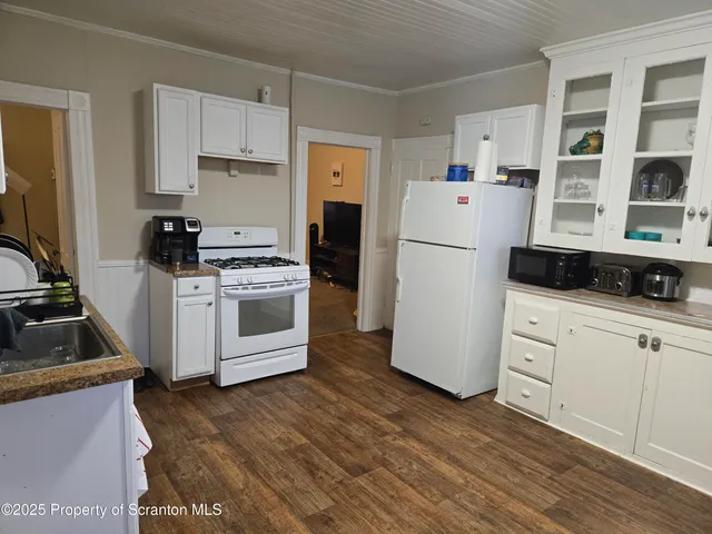 a kitchen with a stove a refrigerator and a stove