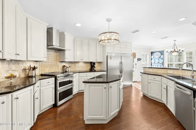 a kitchen with stainless steel appliances granite countertop a sink and cabinets