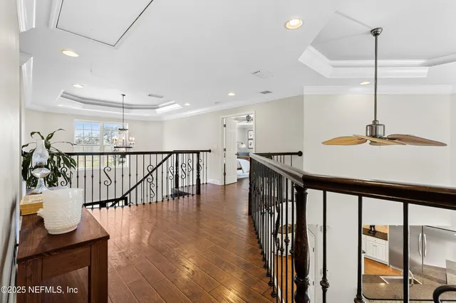 a spacious bedroom with a large bed a flat tv screen and a fireplace