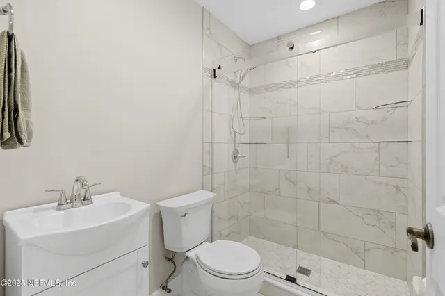 a bathroom with a shower a toilet and a shower